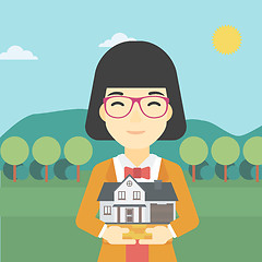 Image showing Woman holding house model vector illustration.