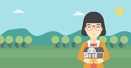 Image showing Woman holding house model vector illustration.