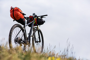 Image showing Bicycle with orange bags for travel