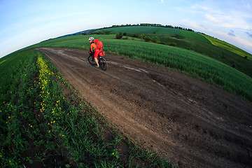 Image showing Young man is riding bicycle outside. Healthy Lifestyle.