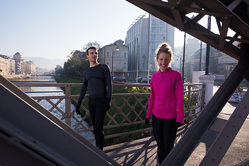 Image showing couple warming up before jogging