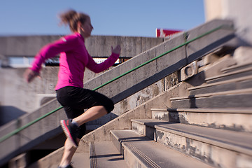 Image showing woman jogging on  steps