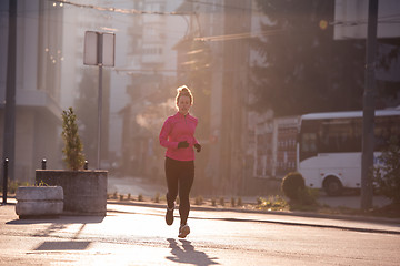 Image showing sporty woman jogging on morning