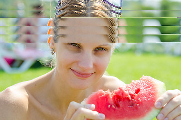 Image showing Young girl eating watermelon, close-up portrait