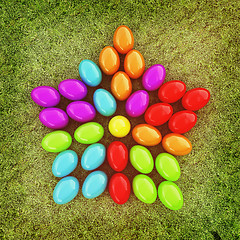 Image showing Colored Easter eggs as a flower on a green grass. 3D illustratio