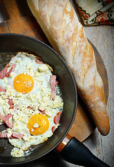 Image showing Fried eggs in a frying pan with bread 