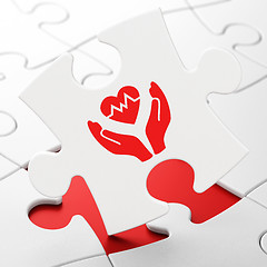 Image showing Insurance concept: Heart And Palm on puzzle background