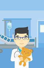 Image showing Pediatrician doctor holding teddy bear.