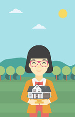 Image showing Woman holding house model vector illustration.