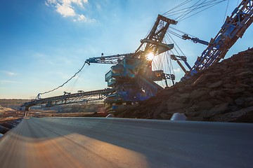 Image showing Long conveyor belt transporting ore