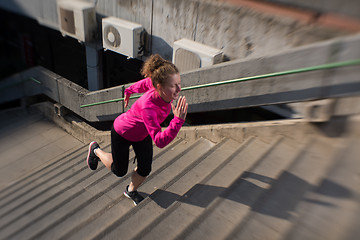 Image showing woman jogging on  steps