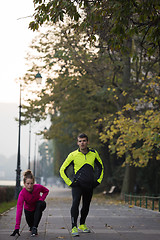 Image showing couple warming up before jogging