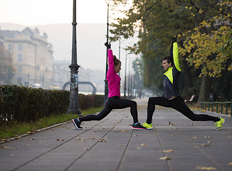 Image showing couple warming up before jogging