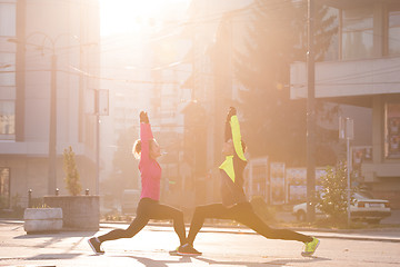 Image showing couple warming up before jogging