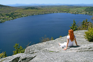 Image showing Young woman enjoying the view over lake