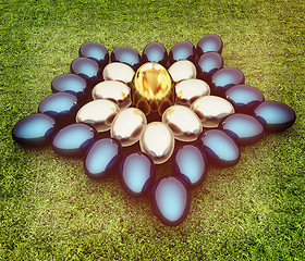 Image showing Blue metallic, metall and Gold Easter eggs as a flower on a gree