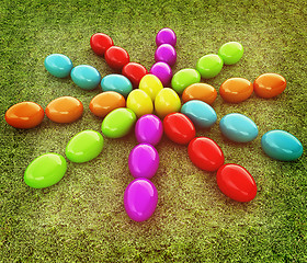 Image showing Colored Easter eggs as a flower on a green grass. 3D illustratio