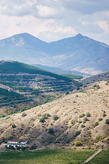 Image showing Silent scenic terrain, hills, mountains and lonely house