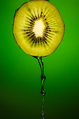 Image showing Piece of kiwi with water drops