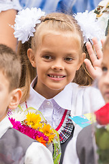 Image showing First grader on the first of September, the line greeting waving friend