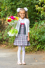 Image showing portrait of a seven-year first-grade girl with a bouquet of flowers