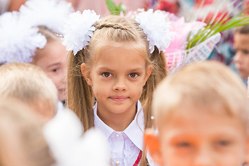 Image showing First grader close-up in a crowd of children on line the first of September