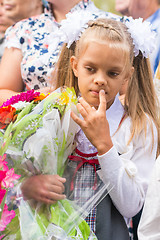 Image showing First grader on the line of the first of September in thought looking down