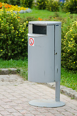 Image showing Neat metal urn on a background of manicured lawns