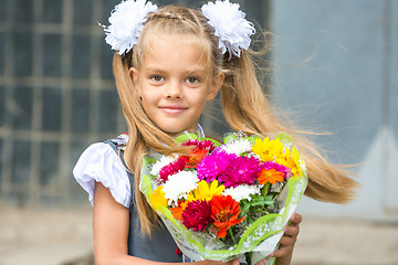 Image showing Up portrait of first-grader with a bouquet of flowers