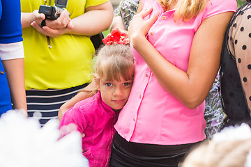 Image showing Five-year girl standing in the crowd and clung to her mother