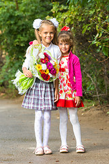 Image showing Portrait first grader and her younger sister on the way to school