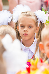 Image showing First grader tired of classmates in the crowd at the first line of September