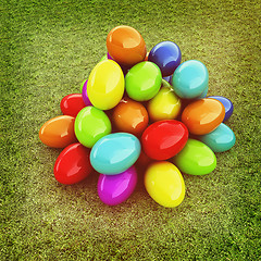 Image showing Colored Easter eggs on a green grass. 3D illustration. Vintage s