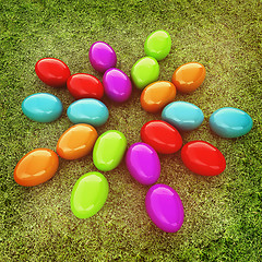Image showing Colored Easter eggs as a flower on a green grass. 3D illustratio