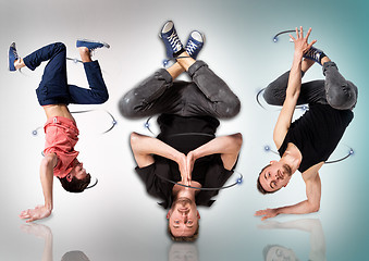 Image showing Break dancers doing handstand against white background