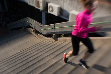 Image showing woman jogging on  steps