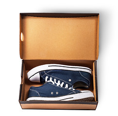 Image showing Dark blue sports shoes inside cardboard box