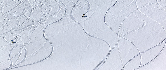 Image showing Snowboarders downhill on off piste slope