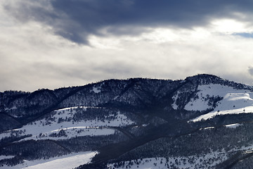 Image showing Winter snow mountains and storm clouds at evening