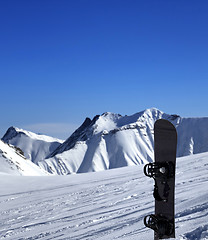 Image showing Snowboard in snow on off-piste slope