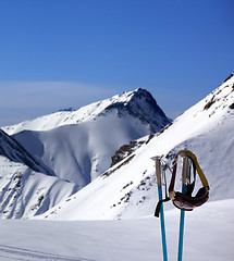 Image showing Ski mask on ski poles and off-piste slope