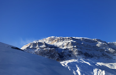 Image showing Snow winter mountains at sun windy morning