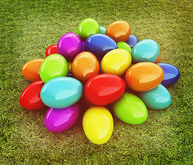 Image showing Colored Easter eggs on a green grass. 3D illustration. Vintage s