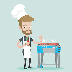 Image showing Man cooking meat on gas barbecue grill.