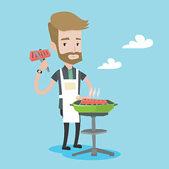 Image showing Man cooking meat on barbecue grill.