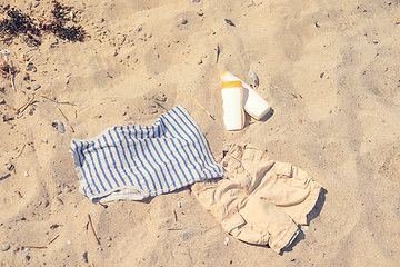 Image showing Kids clothes on a sandy beach