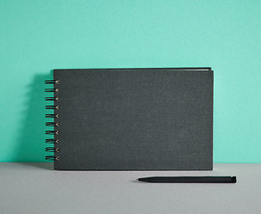 Image showing black notebook and pen