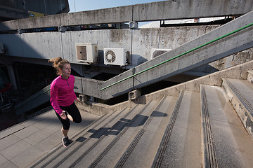 Image showing woman jogging on  steps