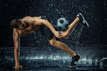 Image showing Water drops around football player