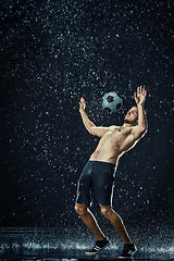 Image showing Water drops around football player